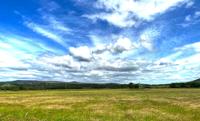 Flat grassy plain, of the Airedale Valley, with the Yorkshire Dales hills, on the horizon near, Skipton, UK