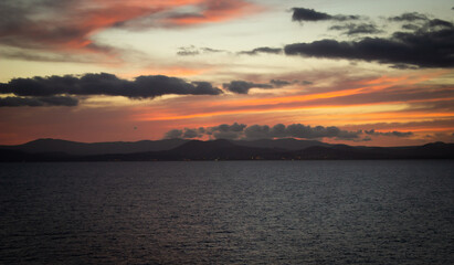 Dramatic sunset over the sea, red - orange sky 