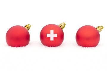 three Christmas balls Switzerland flag in the snow