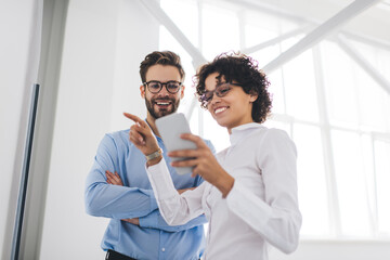 Business man and woman work at interactive board