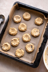 Gluten free raw, uncooked banana cookies with chocolate chips. Healthy homemade biscuits, top view.