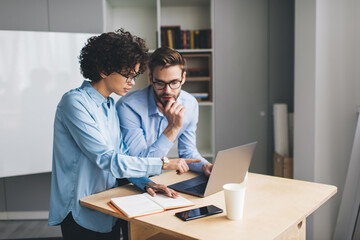 Millenial business man and woman working in office