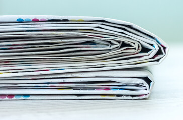 A stack of newspapers. Business news, finance. Latest information. Copy space