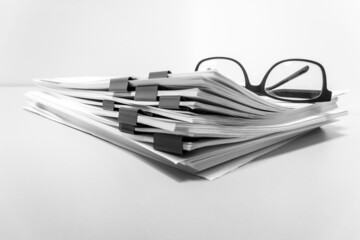 folder with documents and glasses on the desktop. The report is financial. Copy space