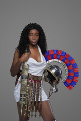 Fototapeta na wymiar Roman african woman with helmet against gray background