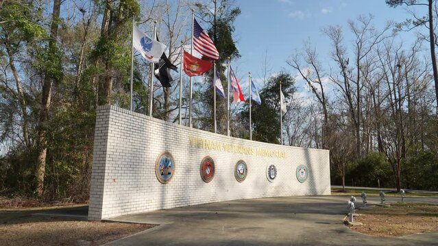 A daytime tilt up establishing shot of the entrance to the Vietnam Veterans Memorial.  