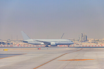 Fototapeta na wymiar Airplane on runway in Doha airport, Qatar