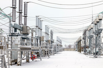 High voltage equipment of a high voltage electrical substation in winter. High voltage transformer...