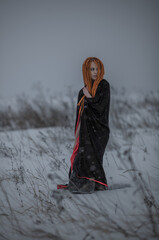 Beautiful young woman standing in the field