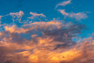 Naklejka na ściany i meble scattered cirrus clouds beautifully illuminated by the setting sun