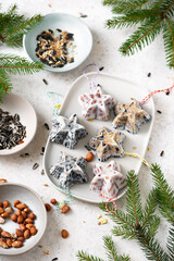 Homemade mini Christmas star shaped cakes, bird feeder for hanging in the garden. Helping wild animals concept.  Selective focus.