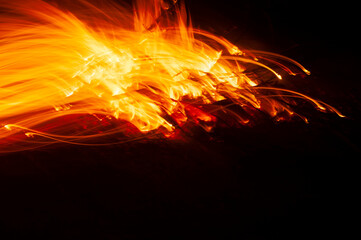 Fototapeta na wymiar Flames of fire from a bonfire, with abstract shapes and in movement