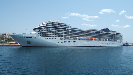Colossal cruise ship liner anchored in port of Piraeus ready to depart for Aegean destination islands, Attica, Greece                                