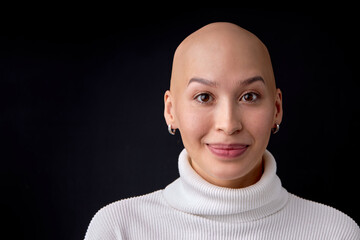 Close-up portrait of positive smiling bald female in casual wear posing looking at camera....