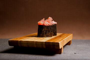 Tuna fish freshly prepared. Japanese food, pieces of tuna, in a wooden background. Fish slices. Front view with Copy Space.