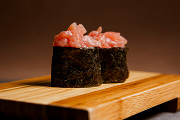 Tuna fish freshly prepared. Japanese food, pieces of tuna, in a wooden background. Fish slices. Front view with Copy Space.