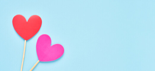 Red and pink hearts on a light blue backdrop. Valentines day background. Flat lay, banner, copy space