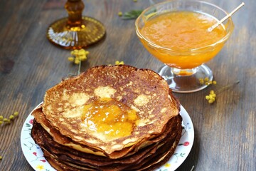 corn pancakes with jam on a dark background , apricot or peach jam, pancake holiday 