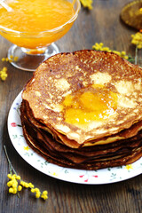 corn pancakes with jam on a dark background , apricot or peach jam, pancake holiday 