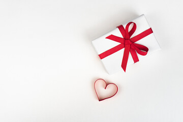 White boxes with red ribbons and decorative heart isolated on white background