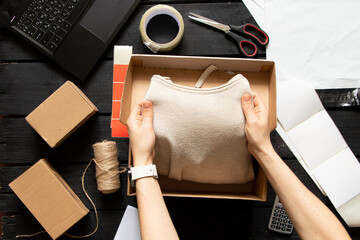 Women's online store, small business owner, entrepreneur, packing bag, mailbox preparing parcel on the table for shipping. Dropshipping delivery concept in e-commerce.Product