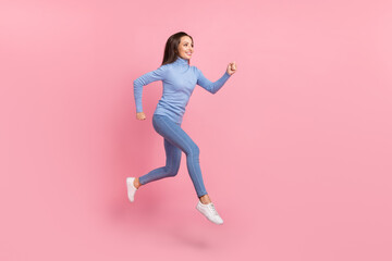 Profile photo of cheerful active lady jump run empty space wear blue turtleneck jeans sneakers...
