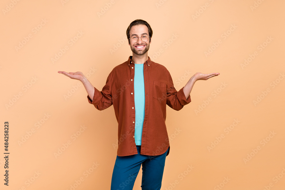 Sticker Photo of cheerful promoter man hands demonstrate empty space wear casual outfit isolated beige color background