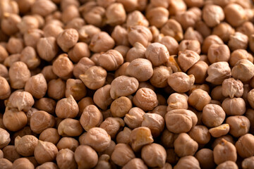 Raw dry chickpeas in plate on rustic table
