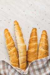 Baked croissant. Crispy bun roll on white table.