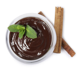 Glass of delicious hot chocolate with fresh mint and cinnamon sticks on white background, top view