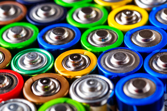 Energy abstract background of colorful batteries.Used batteries from different manufacturers, waste, collection and recycling,Alkaline battery aa size.Concept background of colorful batteries