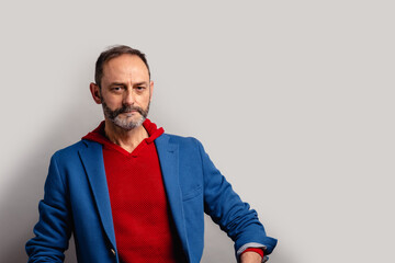 Portrait of sexy mature grey bearded man. Stylish bearded senior bearded man looking at camera isolated on grey background.