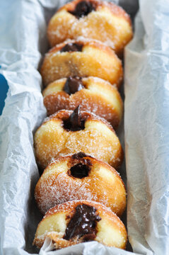 Homemade fried doughnuts with sugar and chocolate filling. Close up.