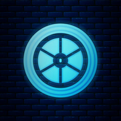 Glowing neon Bicycle wheel icon isolated on brick wall background. Bike race. Extreme sport. Sport equipment. Vector