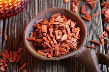 Pieces of red sandalwood on a wooden spoon, close up