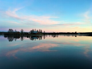Kotisaari Island water reflection at sunset in autumn. Lapland, Finland.