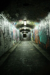 Grungy tunnel with graffitis