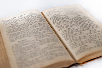 Obraz premium 100 years retro old holy bible book opened with visible text on white background