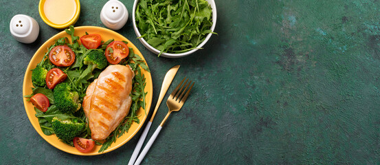 Cooked chicken fillet with fresh vegetable salad. Chicken breast and green vegetables on table. Healthy food, keto diet concept. Healthy lunch menu