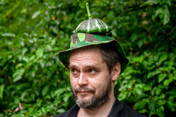  Portrait of a farmer man with a mature juicy pattison on his head