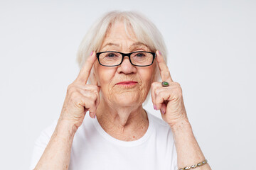 emotional elderly woman health lifestyle eyeglasses treatment light background