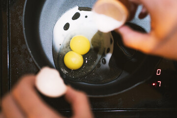 Double Yolks, Fresh Twin Eggs Yolk. Egg in fry pan, each egg with double egg yolk