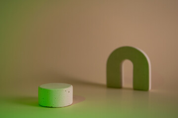 Concrete circle shaped pedestal on green light neon background. Podium mockup background for products. Advertising template. Stone platform. Abstract geometric