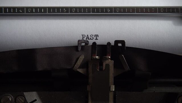 Typing word Past on a vintage typewriter. Close up.