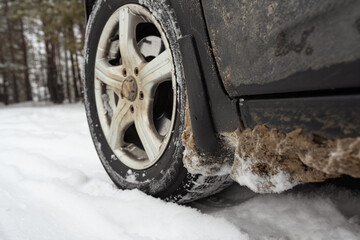Car on snowy road, closeup view. Winter season