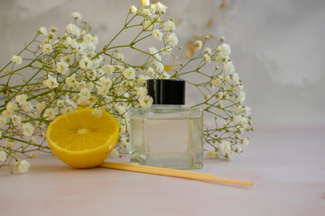 bottle of home fragrance orange, gypsophila flower