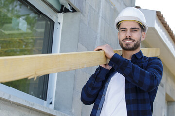 carpenter worker holding wooden boards