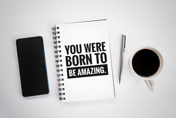 Inspirational motivational quote on a notebook - You were born to be amazing. With spiral book,...