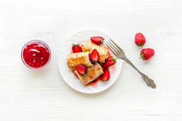 Hot french crepes with strawberry and berry sauce. Sweet dessert
