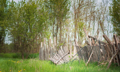View of an old wooden broken fence on a village, rural nature